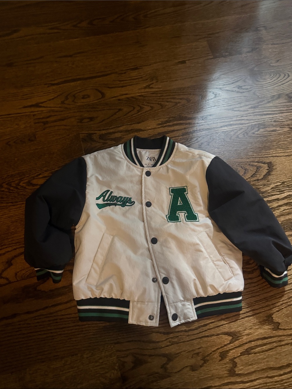 Zara Kids White Jacket with Black Sleeves and Green Lettering